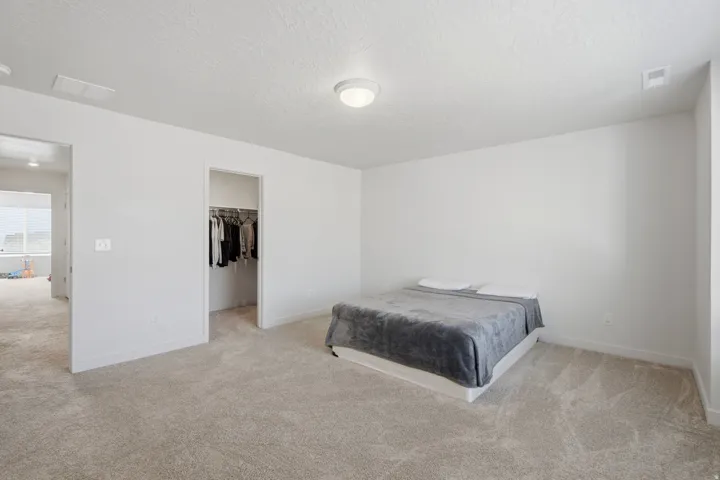 Carpeted interior space featuring light neutral wall paint