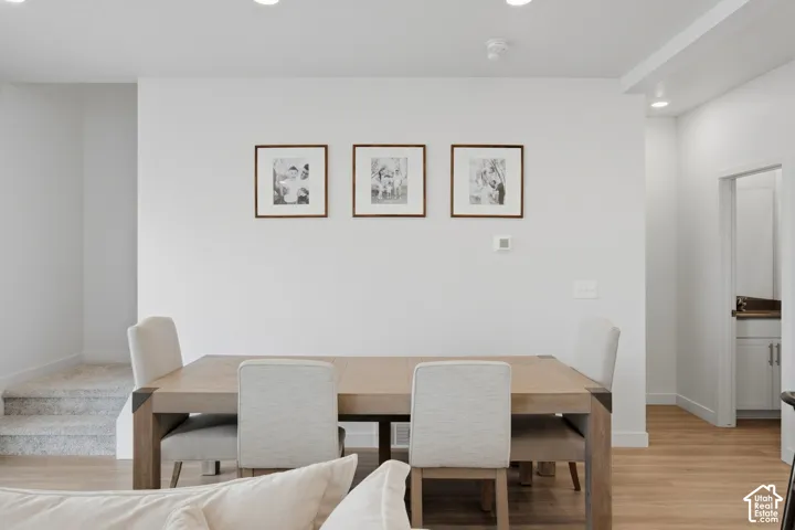 Open-concept living space with recessed lighting and light wood-finish flooring