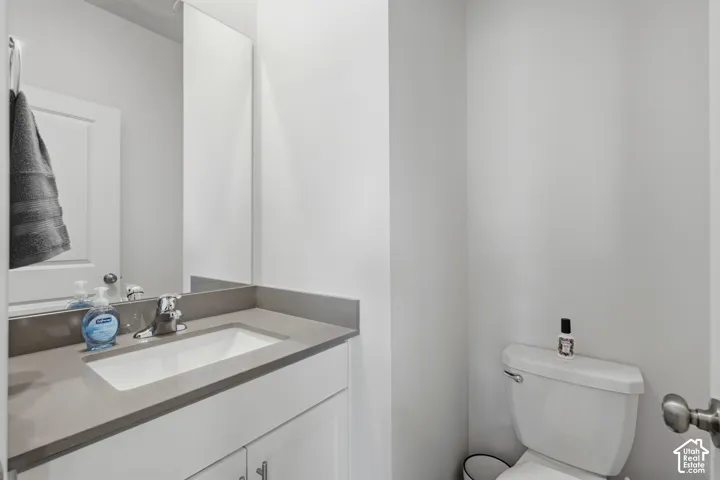 Vanity with a rectangular undermount sink, gray countertop, and chrome faucet