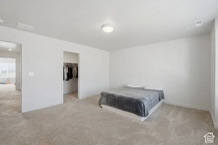 Carpeted interior space featuring light neutral wall paint