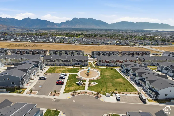 Community park with green space and playground equipment, surrounded by multi-story residential buildings