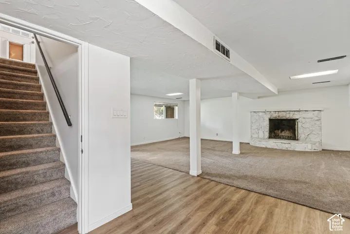 Carpeted staircase with black handrail