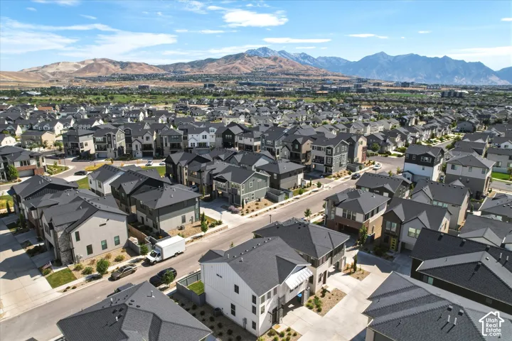 Expansive neighborhood featuring a variety of contemporary-style homes with dark-toned roofs and light-colored exteriors