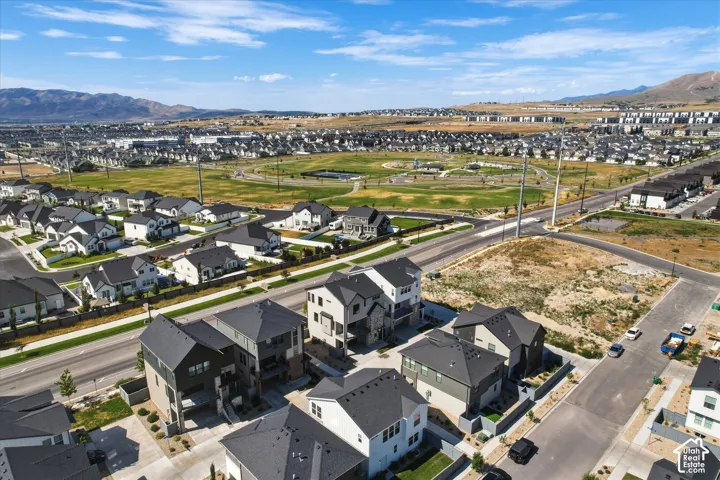 Expansive aerial showcasing a residential neighborhood featuring contemporary homes with dark roofs and light-toned siding