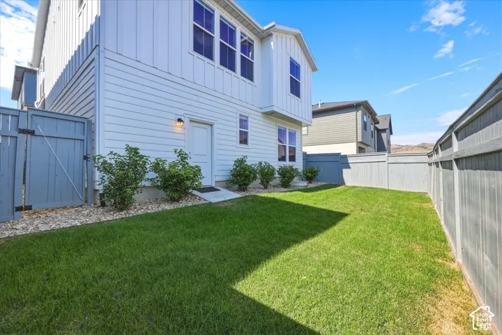Private backyard featuring a well-maintained lawn