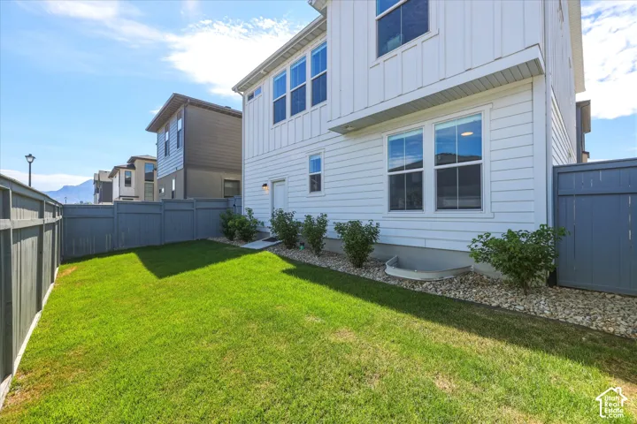 Expansive fenced yard featuring a manicured lawn and privacy fencing