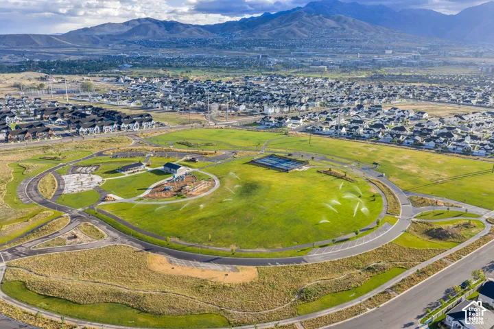 Expansive green spaces with integrated walking paths, multiple recreational areas, and surrounding residential developments
