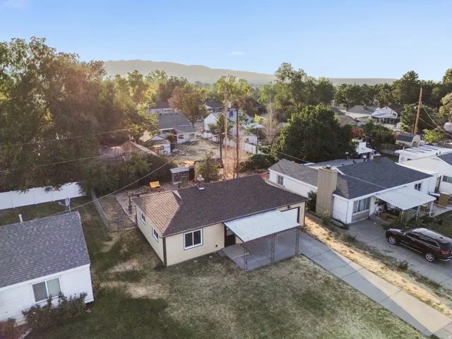 Single-story residence with a covered carport, concrete driveway, and a fenced backyard