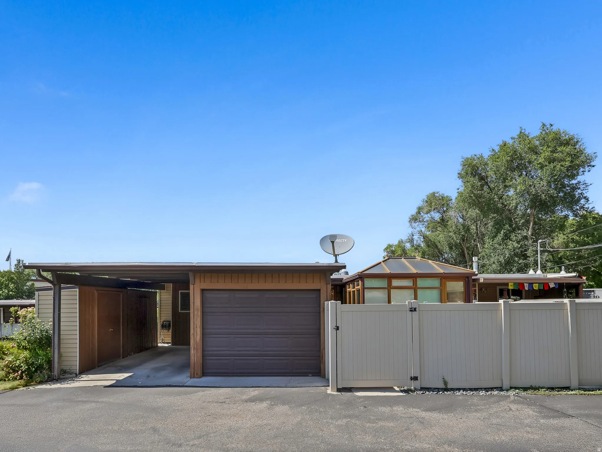 Attached garage with an additional covered carport