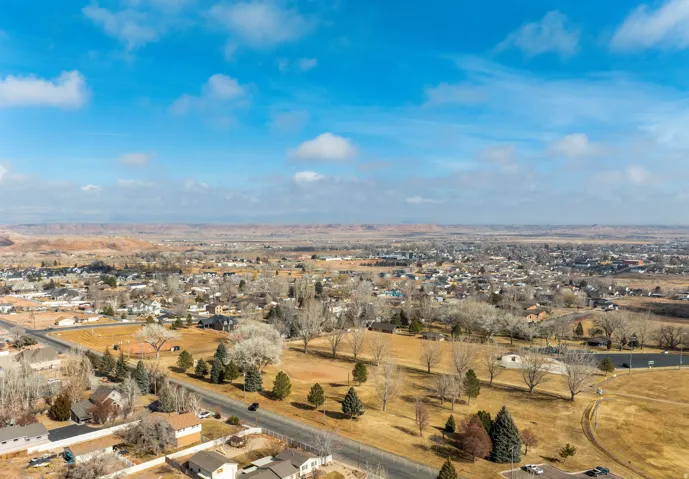 Expansive aerial perspective showcasing a residential neighborhood with surrounding open terrain