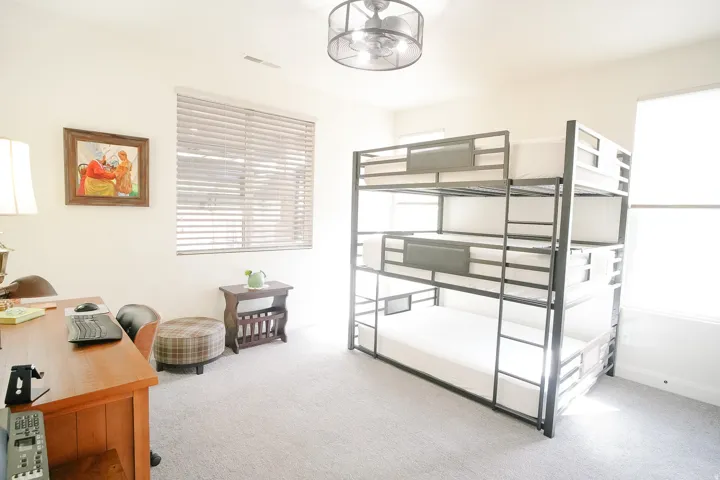 Spacious room featuring light-toned carpeting and a contemporary ceiling fan with integrated lighting