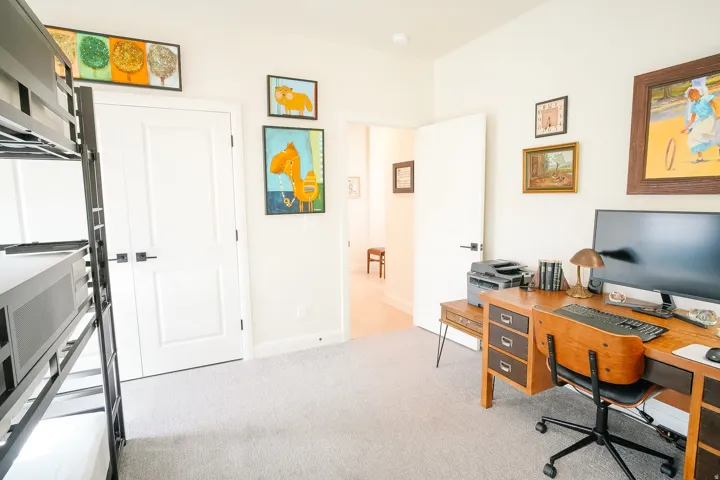 Carpeted interior room with two white panel doors, high ceilings, and light-colored walls