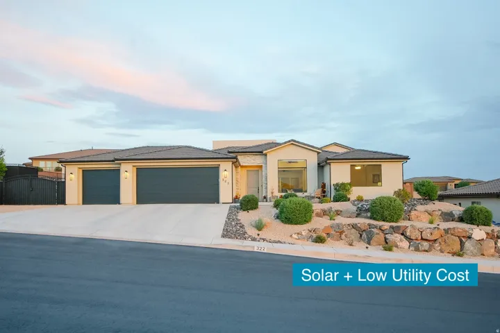 Contemporary stucco exterior featuring a two-car garage, an additional single-car garage, and a concrete driveway