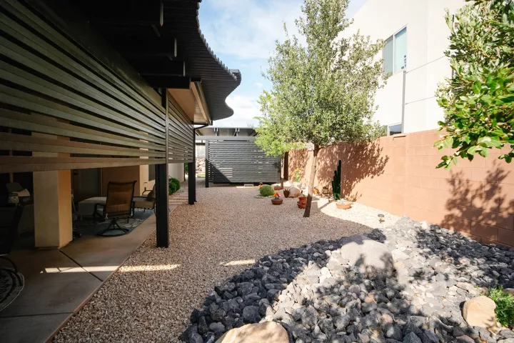 Low-maintenance landscaping featuring gravel and decorative rock elements