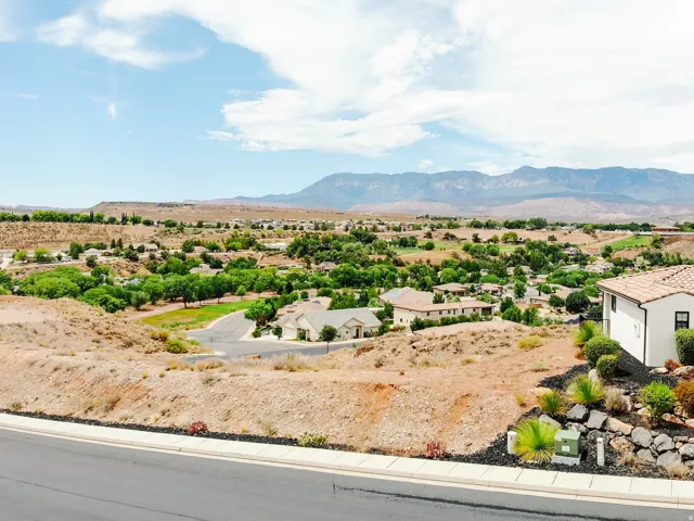 Southwestern-style architecture with a tile roof, surrounded by desert landscaping and distant mountains