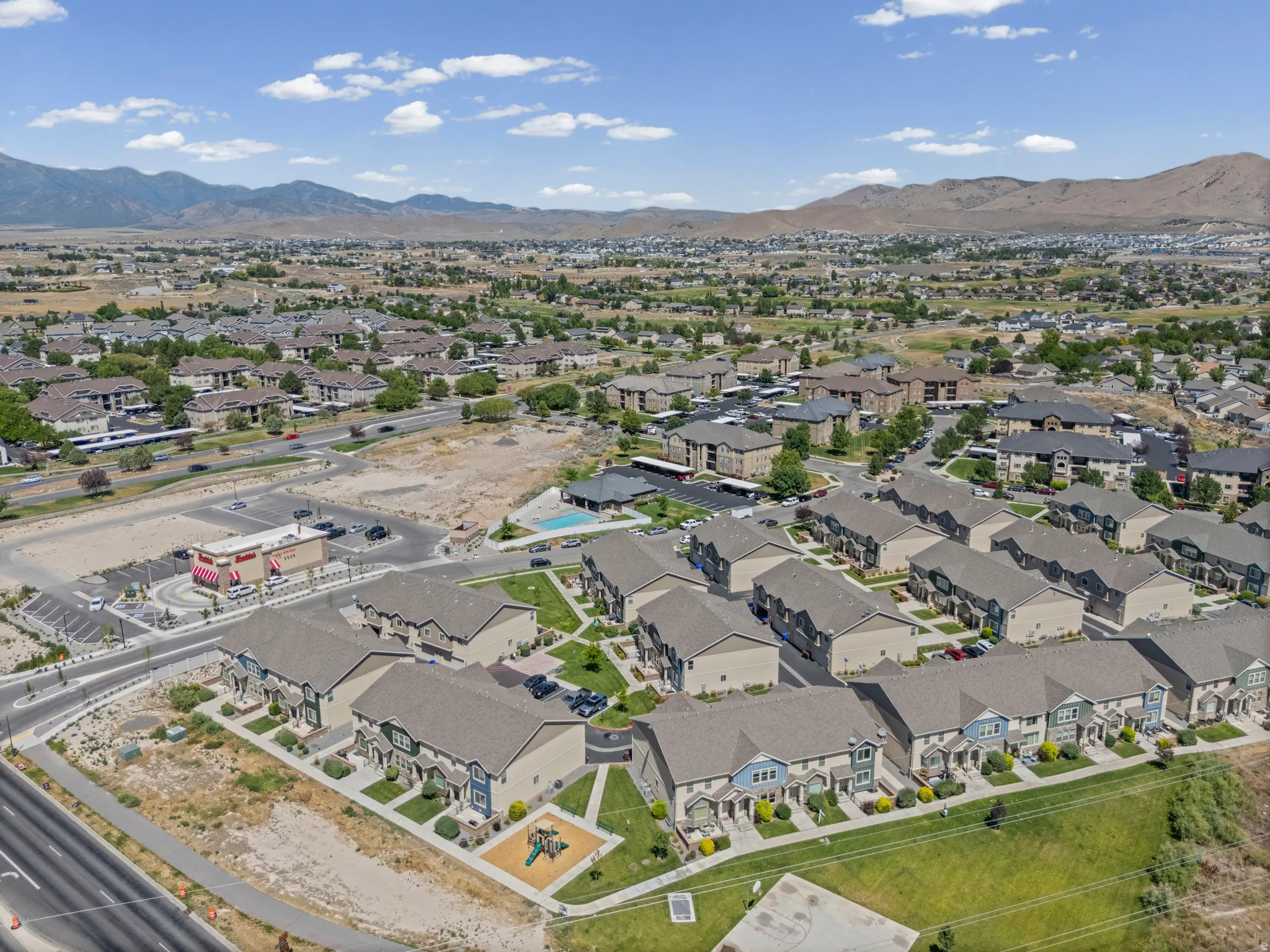 Aerial perspective of a structured community featuring multi-level townhomes