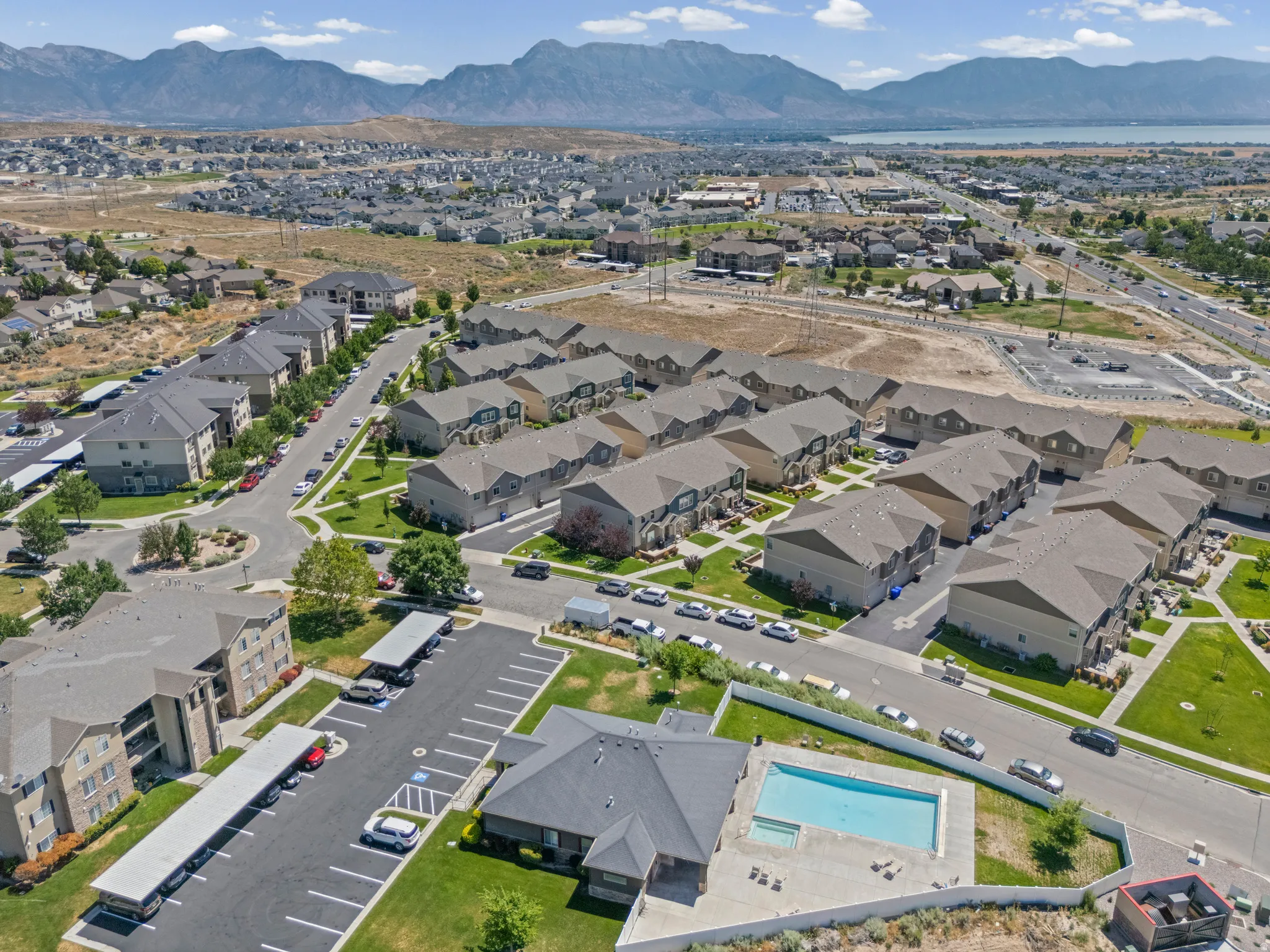 Aerial perspective showcasing a residential community with multi-story buildings and townhome-style residences
