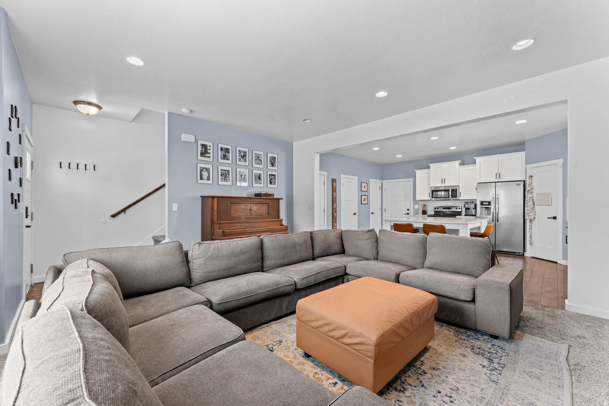 Open-concept living area featuring recessed lighting and light blue accent walls