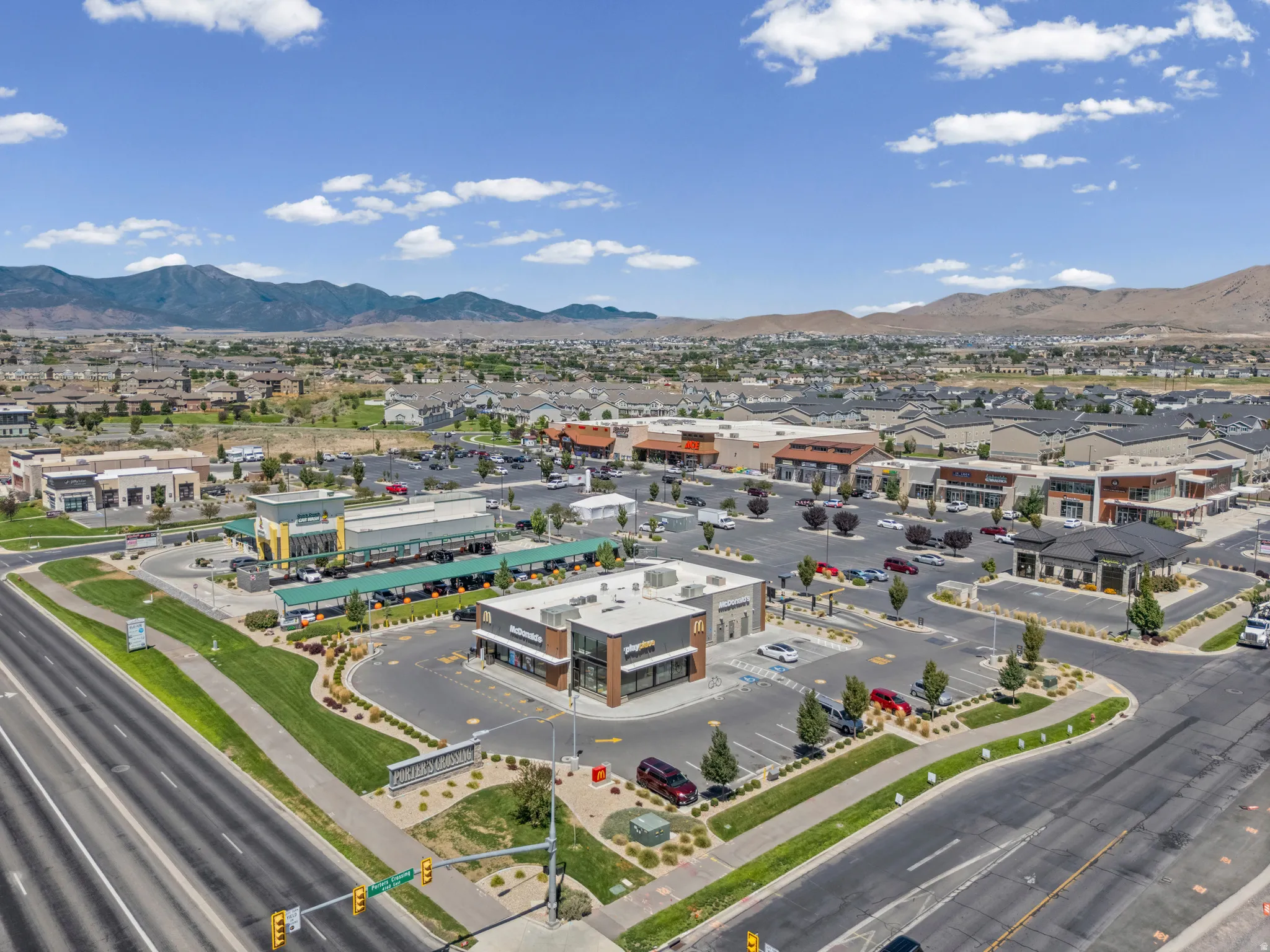 Expansive commercial retail development featuring multiple buildings, surface parking, and manicured landscaping