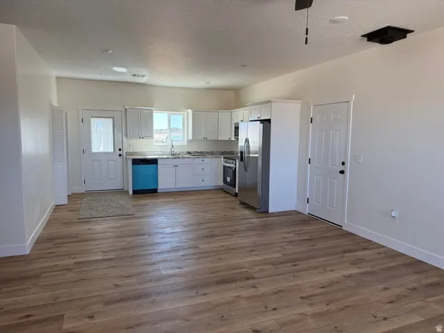Open-concept living area with wood-finish flooring