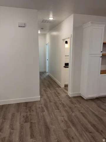 Hallway featuring wood-finish flooring and recessed lighting