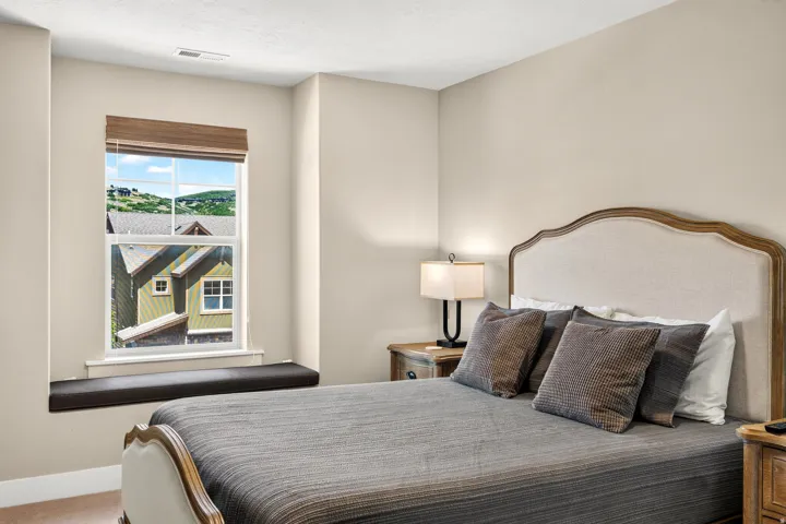 Bedroom featuring a window seat, neutral wall tones, and plush carpeting