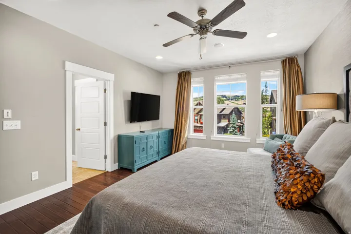 Bedroom featuring dark wood-finish flooring, recessed lighting, and a ceiling fan with integrated light