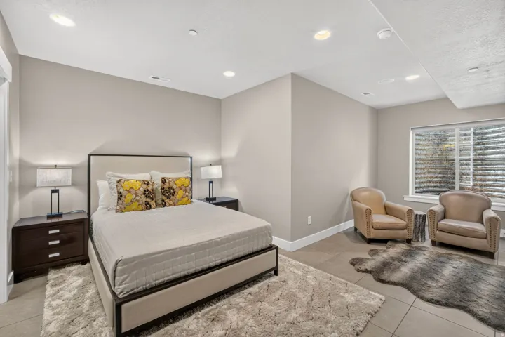 Bedroom featuring recessed lighting, a window with horizontal blinds, and tile flooring