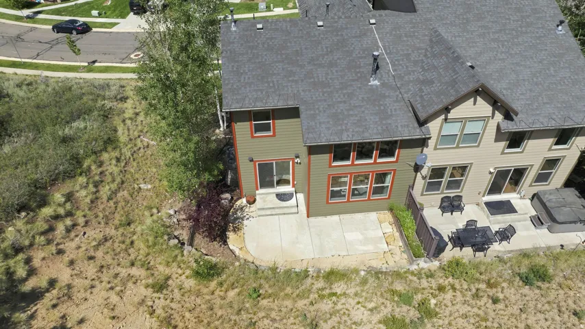 Rear exterior featuring a multi-level patio with concrete surfacing