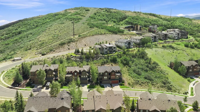 Modern residential community on a verdant hillside with multi-story homes