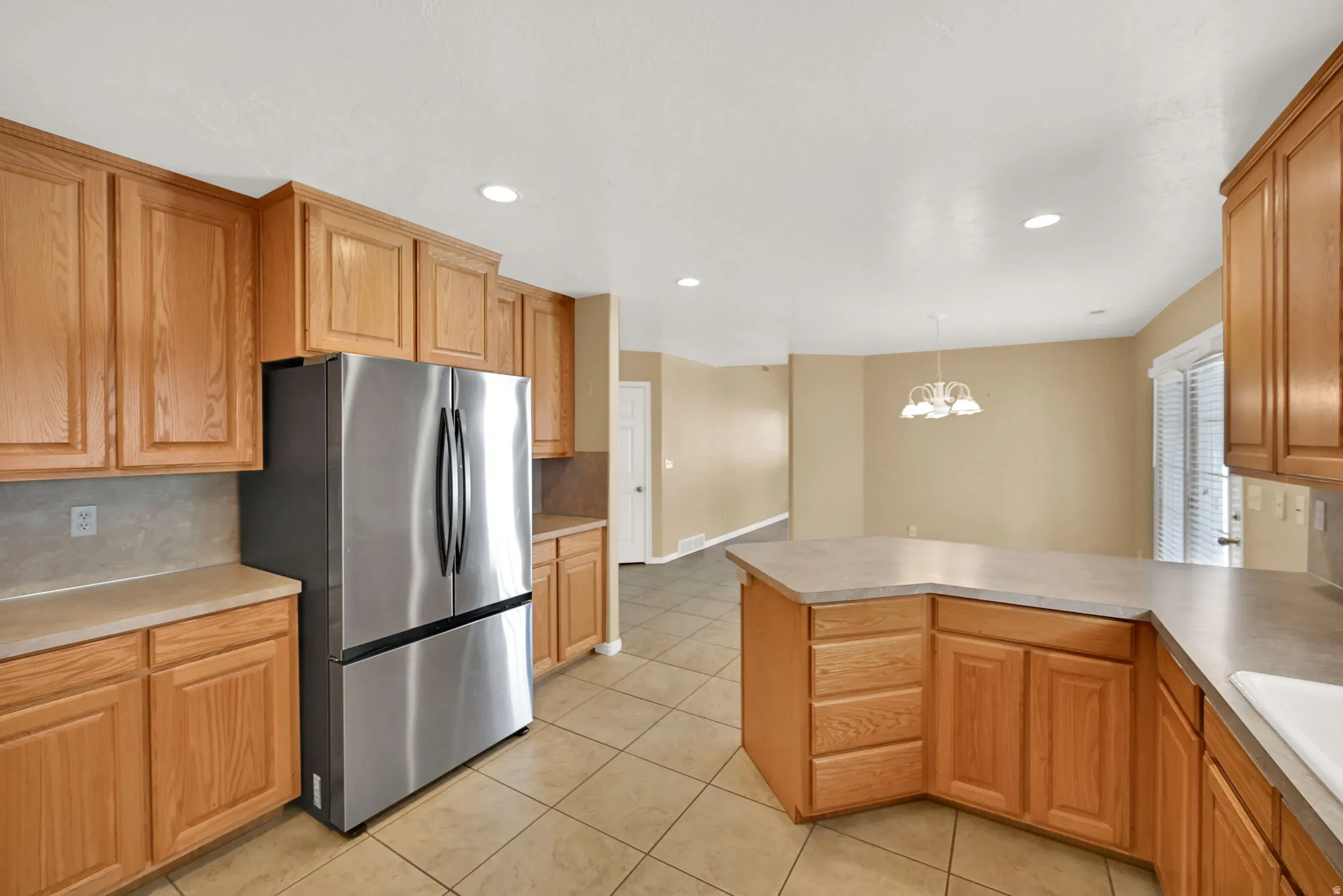 Spacious kitchen featuring NEW stainless steel French door refrigerator and tile flooring