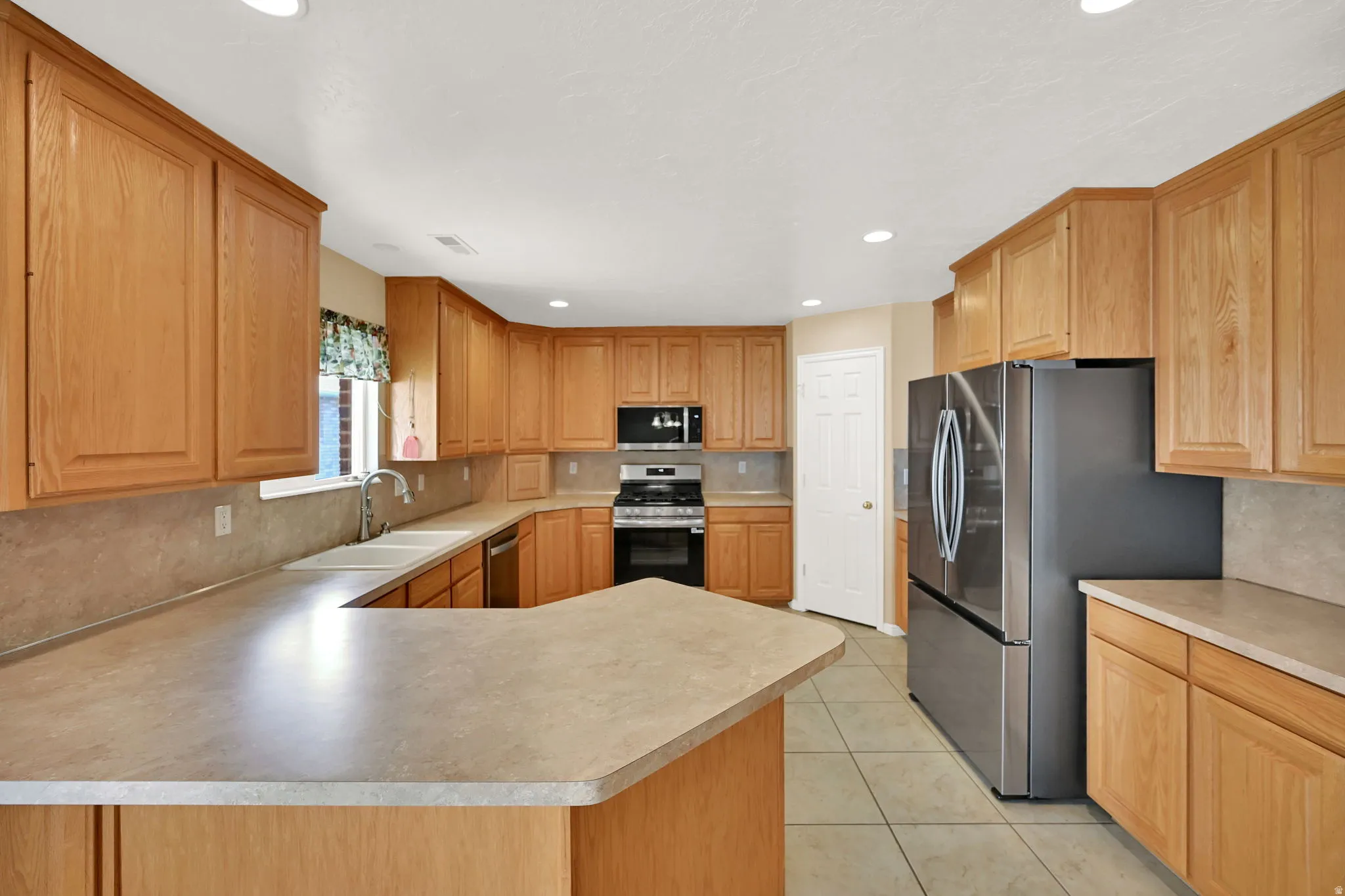 Kitchen featuring NEW stainless steel appliances, and recessed lighting