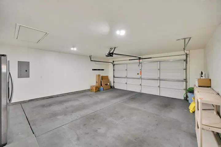 Attached garage space with 2nd refrigerator and shelving