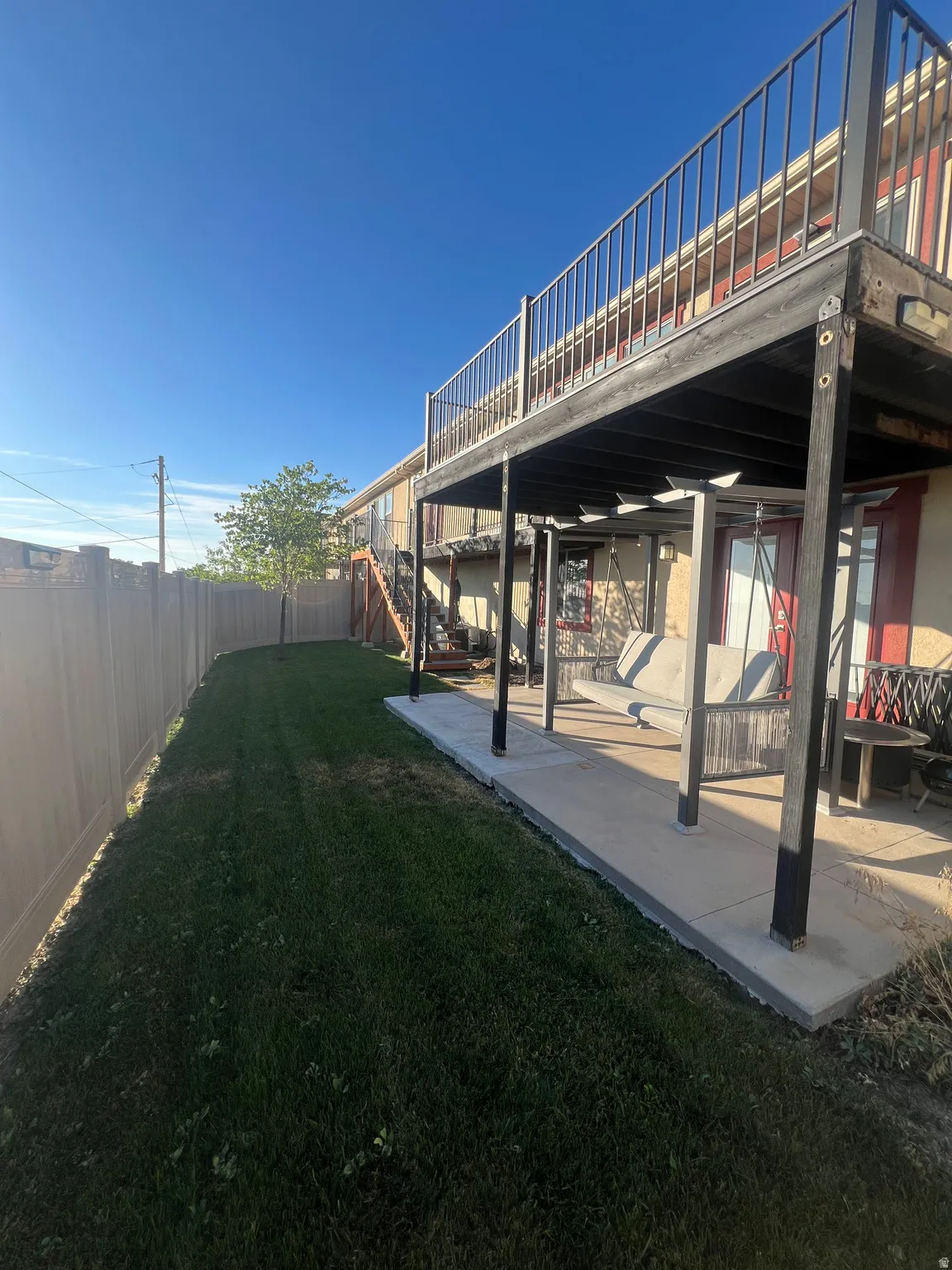 Expansive grassy yard with a privacy fence
