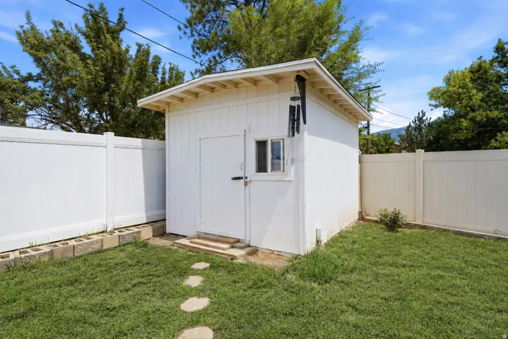Detached storage shed with a gabled roof and a single window