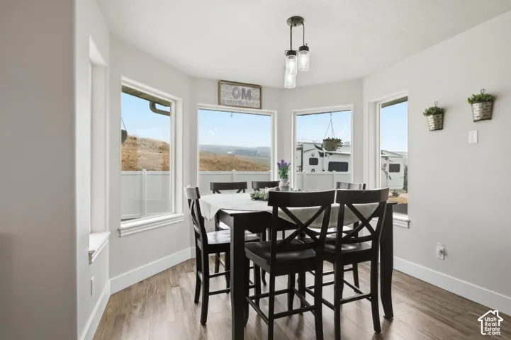 Dining space with wood-finish flooring and white baseboards