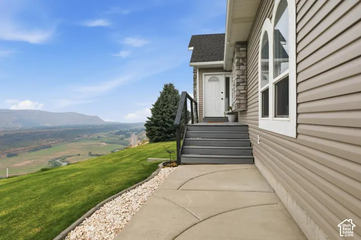 Exterior featuring tan horizontal siding and stone accents