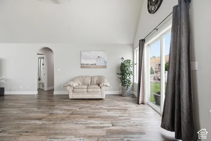 Spacious interior featuring vaulted ceilings and wood-finish flooring
