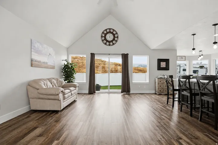 Spacious interior featuring vaulted ceilings and wood-finish flooring