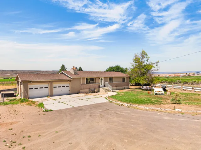 Ranch-style residence featuring a two-car garage with panel doors