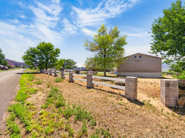 Property boundary defined by a block and white rail fence