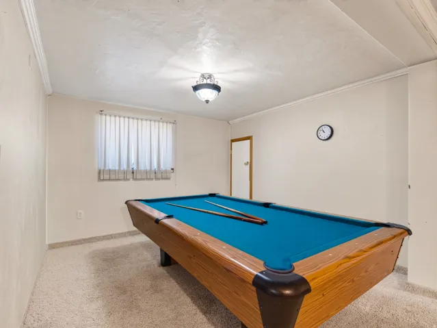 Recreational room featuring a billiard table, textured ceiling, and a ceiling-mounted light fixture