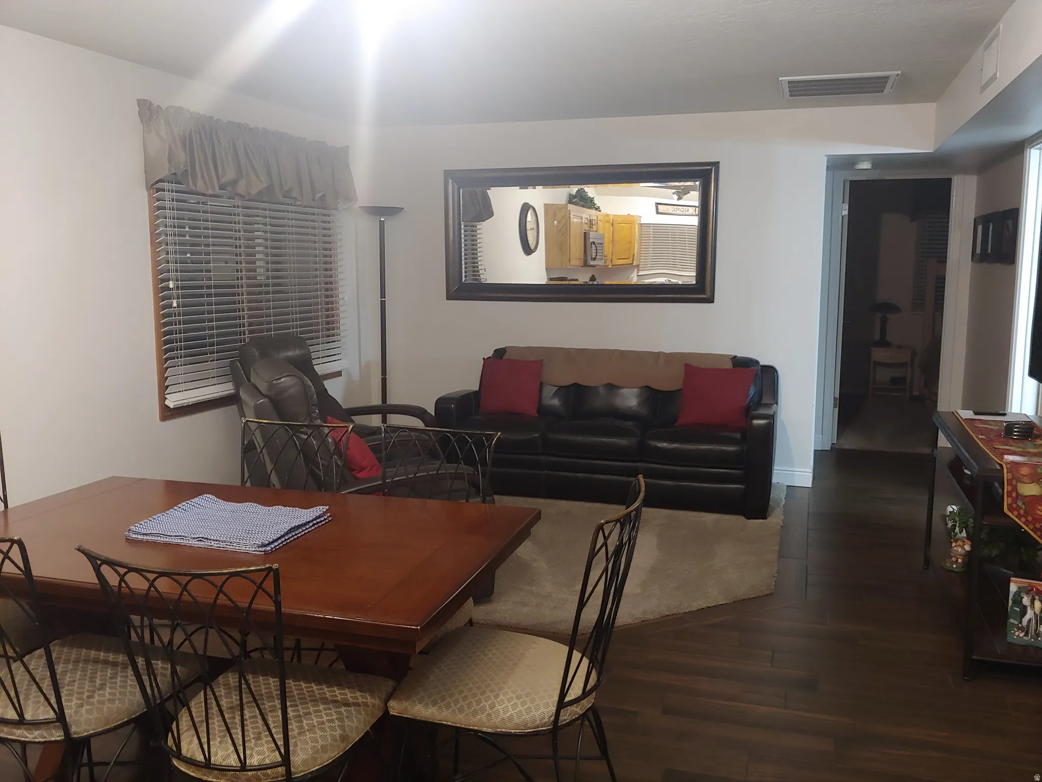 Open-concept living area featuring rich wood-finish flooring