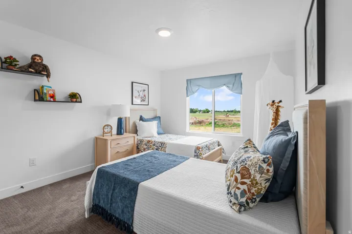 Bright interior space featuring a window with exterior visibility, recessed ceiling lighting, and two individual beds