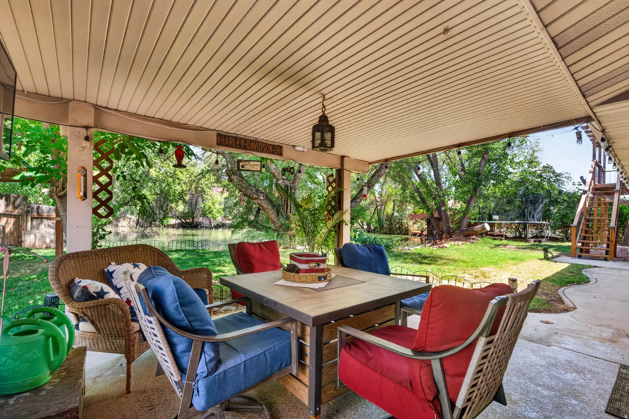 Covered patio featuring a slatted ceiling, a concrete floor, and a lattice privacy screen