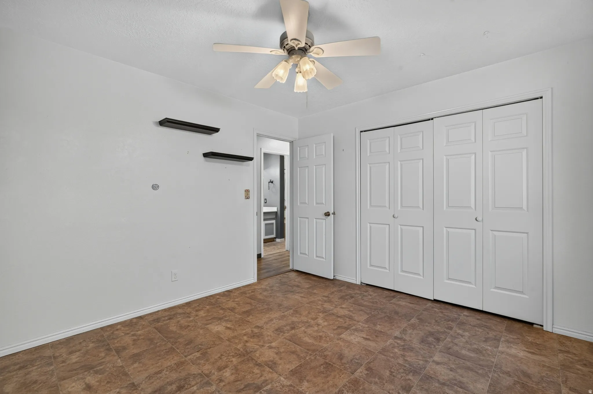 Neutral white walls complemented by a brown-toned tile floor