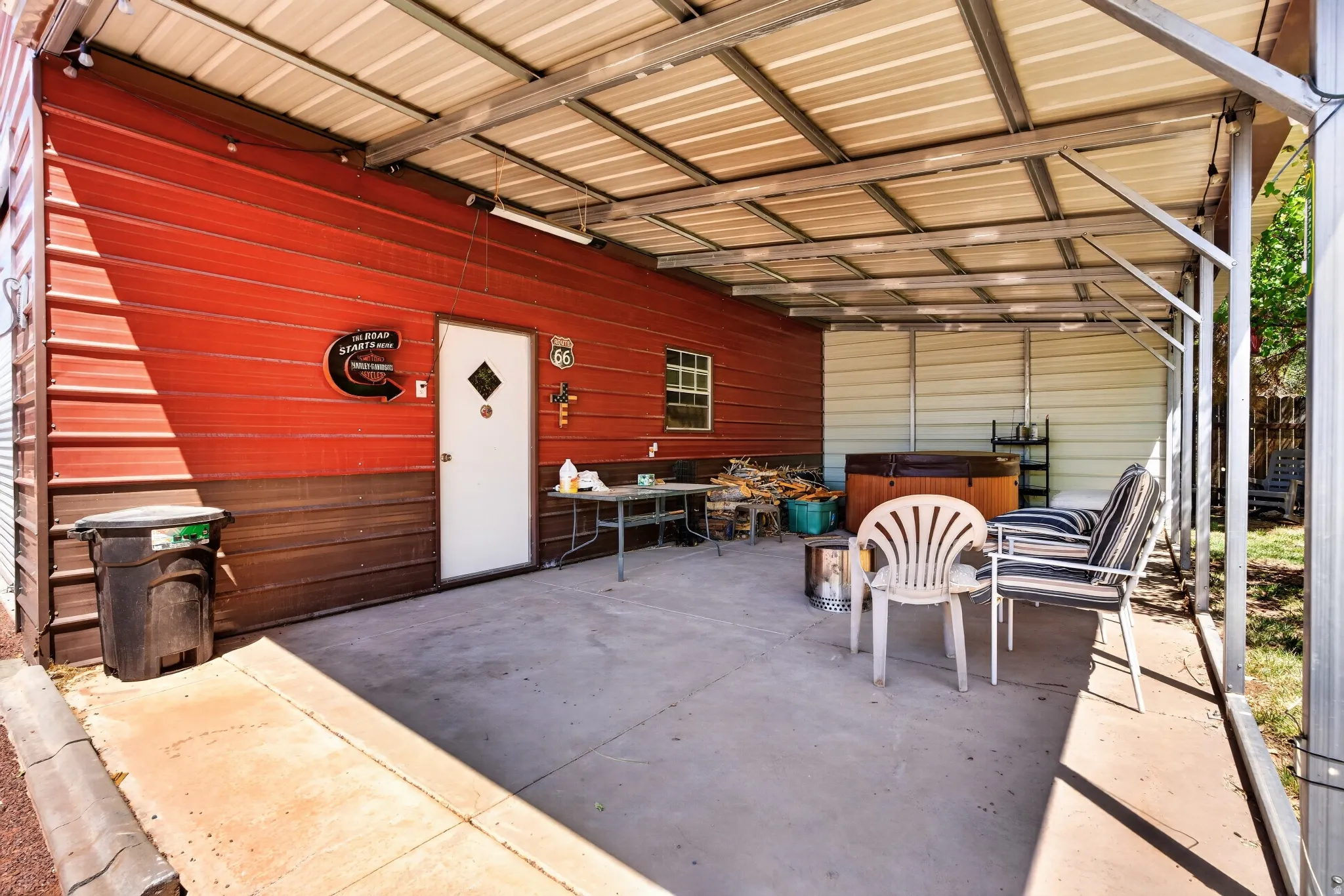 Covered patio featuring a concrete slab and a metal roof structure