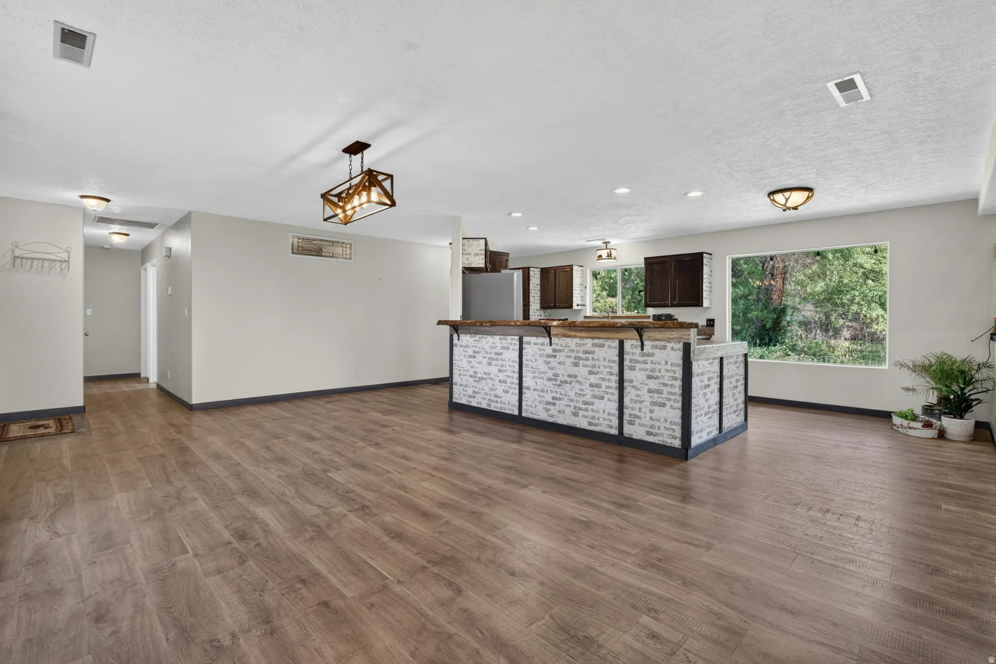 Spacious open-concept interior featuring wood-finish flooring throughout