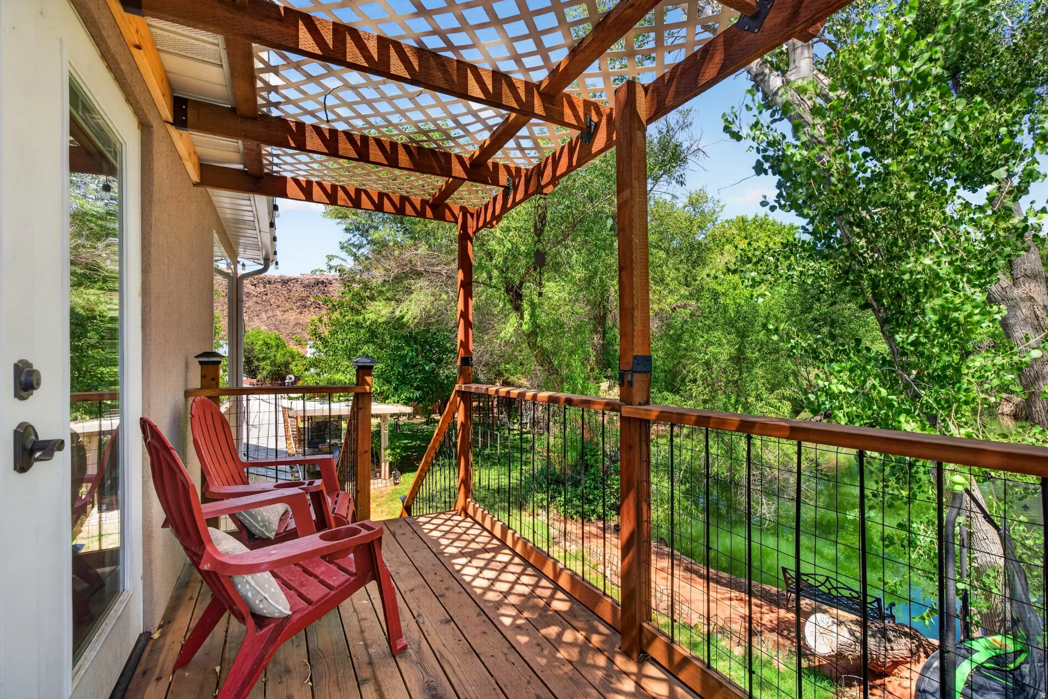 Covered deck with wood flooring and lattice ceiling