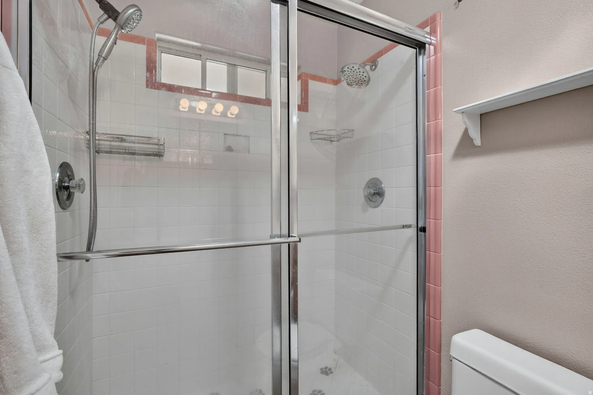 Enclosed shower with clear glass door and chrome hardware